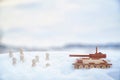 A wooden toy tank and little men in the snow. Russia and Ukraine are at war in winter. Encirclement, retreat, attack Royalty Free Stock Photo