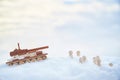 A wooden toy tank and little men in the snow. Russia and Ukraine are at war in winter. Encirclement, retreat, attack Royalty Free Stock Photo