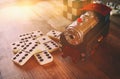 Wooden toy train and domino over wooden table Royalty Free Stock Photo