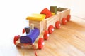 Wooden toy train over wooden floor. selective focus. retro filtered Royalty Free Stock Photo