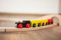 Wooden toy train on railroad with wooden bridge. Clean laminated floor Royalty Free Stock Photo