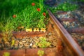 Wooden toy train on real railway tracks Royalty Free Stock Photo