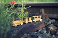 Wooden toy train on real railway tracks Royalty Free Stock Photo