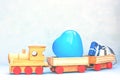 Wooden toy train with some gifts and blue heart shaped balloon. Greeting card for Birthday, Mather`s day, Father`s Day