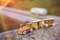 Wooden toy train on wall above a freeway