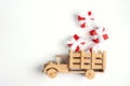 Wooden toy truck with red gift boxes in the back on white background Royalty Free Stock Photo