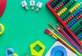 Wooden toys, shape sorter board on green background. Back to school. Close up. Top view, copy space. Education Royalty Free Stock Photo