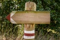 Wooden track pointer on the road in the woods Royalty Free Stock Photo