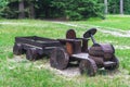 Wooden tractor made from logs in the playground