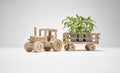 Wooden tractor with trailer, transports small trees. Concept of safeguarding nature and the environment and deforestation. Concept Royalty Free Stock Photo