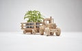 Wooden tractor with trailer, transports small trees. Concept of safeguarding nature and the environment and deforestation. Concept Royalty Free Stock Photo