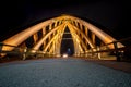 Wooden traffic bridge in the evening with illuminated curved lin