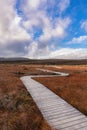 Wooden trail through beautiful countryside towards a mountain. Cuilcagh Boardwalk Trail in Fermanagh, Northern Ireland Royalty Free Stock Photo