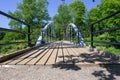 Wooden trail with small bridge through wood forest with heave planks in wood