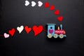 Wooden train with tied hearts. Cute symbol for celebrating Valentine\'s Day. Copy space