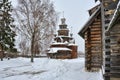 Wooden Transfiguration Church Framed by Trees and Corner of Another Church in Winter