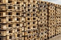 Wooden transport pallets in stacks.