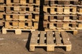 Wooden transport pallets in stacks.