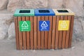 A wooden trash bin for different garbage with an inscription in English (Plastic, metal and Others) Royalty Free Stock Photo