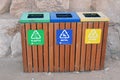 A wooden trash bin for different garbage with an inscription in English (Plastic, metal and Others) Royalty Free Stock Photo