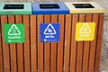 A wooden trash bin for different garbage with an inscription in English (Plastic, metal and Others) Royalty Free Stock Photo