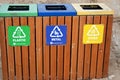 A wooden trash bin for different garbage with an inscription in English (Plastic, metal and Others) Royalty Free Stock Photo