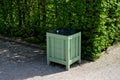 wooden trash park trash can. lined with wood. panelling. cylindrical shape with a