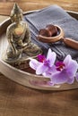 Wooden tray with Buddha and orchid flowers for spirituality and massage