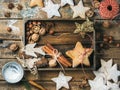 Wooden tray with cookies, decorative angels and stars, cinnamon, nuts Royalty Free Stock Photo