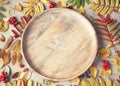 Wooden tray, fallen leaves and berries. Autumn background