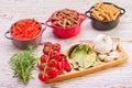 Wooden tray filled with a variety of fresh ingredients used in Italian cuisine, pasta, cherr Royalty Free Stock Photo