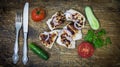 On a wooden tray grilled chicken with vegetables