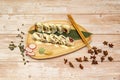 Wooden tray with a portion of sushi uramaki california roll of white rice with tuna, Royalty Free Stock Photo