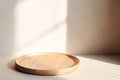 A wooden tray sits on a table next to a wall