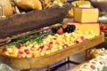 Wooden tray with sliced gouda cheese decorated with strawberries, black grapes and rosemary on the table Royalty Free Stock Photo