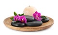 Wooden tray with spa stones, orchid flowers and candle Royalty Free Stock Photo