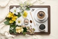 Wooden tray with tablet, coffee and spring flowers on clean white bedding Good morning concept. Generative AI Royalty Free Stock Photo