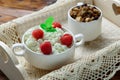 Wooden tray with tasty breakfast : cottage cheese with fresh raspberries and granola. Royalty Free Stock Photo