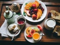 A wooden tray topped with plates of food. AI generative image.