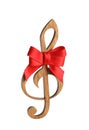 Wooden treble clef with bow on white background