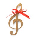 Wooden treble clef with red bow knot on white background Royalty Free Stock Photo