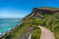 Wooden trek, path on a cliff with ocean on the background