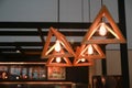 Wooden triangle pendant lamp in coffee shop