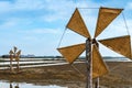Wooden turbine at salt pan using for press seawater up to field with blue sky background in summer time of Thailand,South East Royalty Free Stock Photo