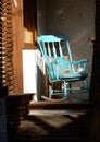 Wooden turquoise rocking chair on the veranda, selective focus Royalty Free Stock Photo