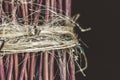 Wooden twigs tied with old string in bunch, dark background