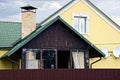 A wooden veranda next to a private house behind a fence Royalty Free Stock Photo