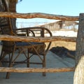 Wooden veranda with a wicker chair