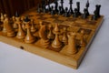 Wooden vintage chess pieces on a chessboard close-up. Playing chess. Strategy, planning, business game concept Royalty Free Stock Photo