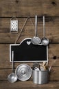 Wooden vintage kitchen background with old kitchenware, blackboard and spoons for cooking fans. Royalty Free Stock Photo